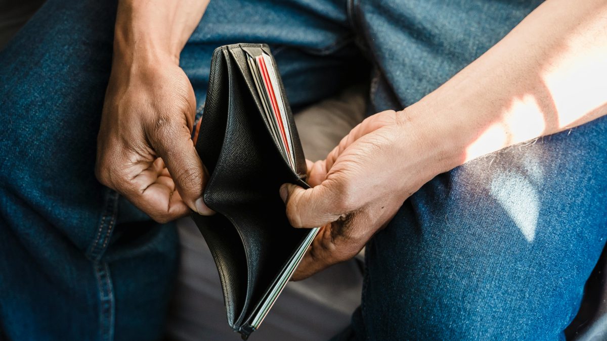A man opening an empty wallet